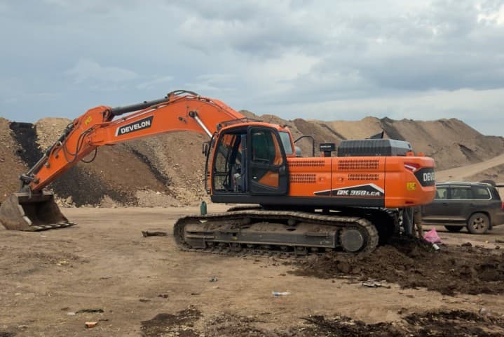 Develon DX360LCA 36-ton heavy crawler excavator operating at a quarry and road construction site in Ethiopia