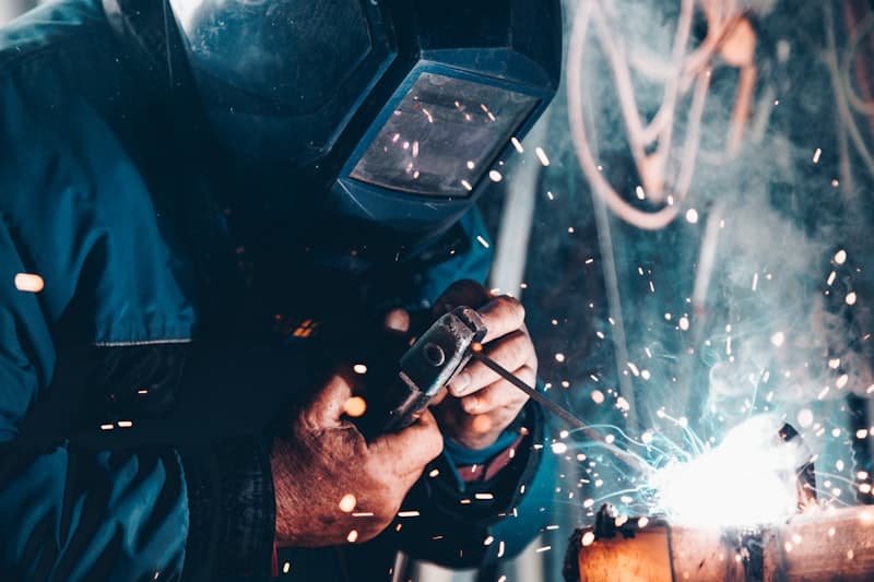 Mechanic performing preventive maintenance on a heavy duty wheel loader
