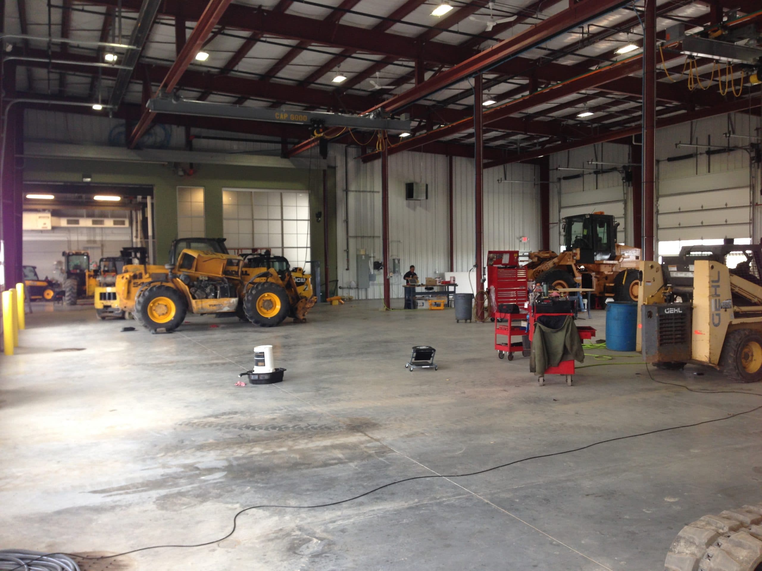 Technician performing scheduled maintenance on heavy construction equipment
