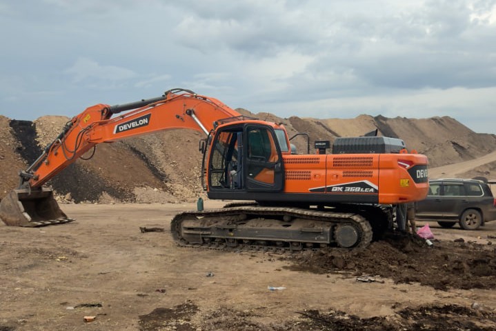 Develon DX360LCA 36-ton heavy crawler excavator operating at a quarry and road construction site in Ethiopia