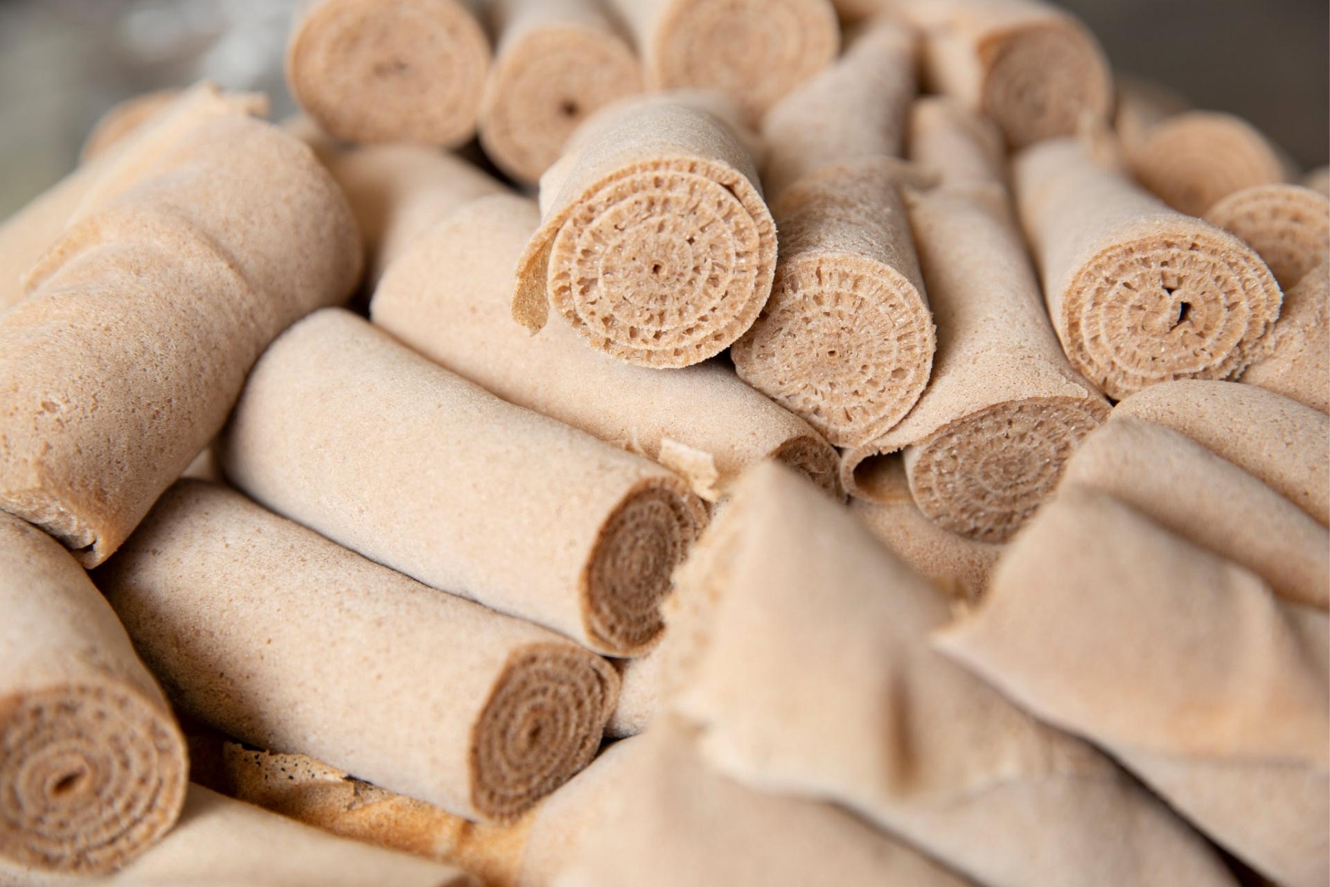 Freshly prepared stack of authentic Ethiopian sourdough teff injera rolls showing classic spongy honeycomb texture
